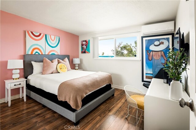 72994 Homestead Dr Unit 29, Palms, CA 92277 - bedroom with a wall mounted air conditioner and dark wood-type flooring