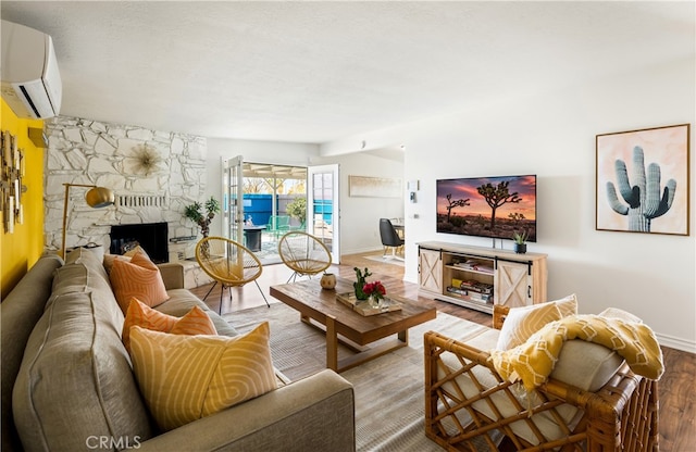 72994 Homestead Dr Unit 29, Palms, CA 92277 - living area with wood finished floors, a wall unit AC, baseboards, and a fireplace