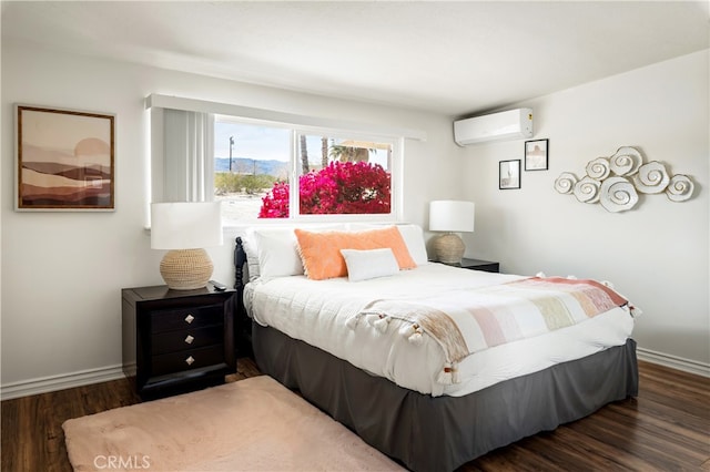 72994 Homestead Dr Unit 29, Palms, CA 92277 - bedroom featuring an AC wall unit, wood finished floors, and baseboards