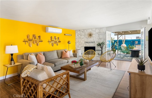 72994 Homestead Dr Unit 29, Palms, CA 92277 - living area featuring a wall mounted air conditioner, wood finished floors, and a fireplace