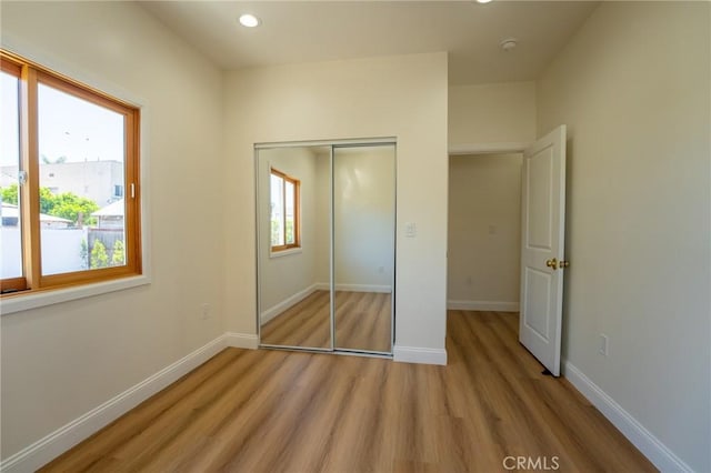 1532 W 22nd St, Los Angeles, CA 90007 - unfurnished bedroom with light wood finished floors, a closet, recessed lighting, and baseboards