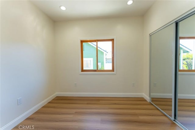1532 W 22nd St, Los Angeles, CA 90007 - unfurnished bedroom with a closet, light wood-style floors, recessed lighting, and baseboards