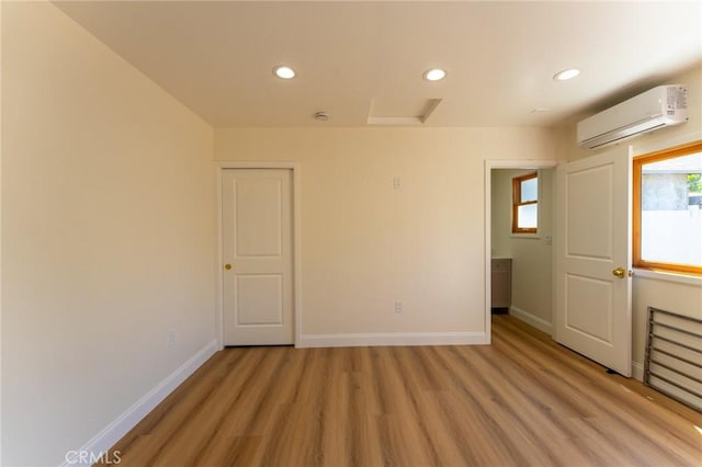 1532 W 22nd St, Los Angeles, CA 90007 - spare room featuring a wall unit AC, light wood finished floors, and recessed lighting