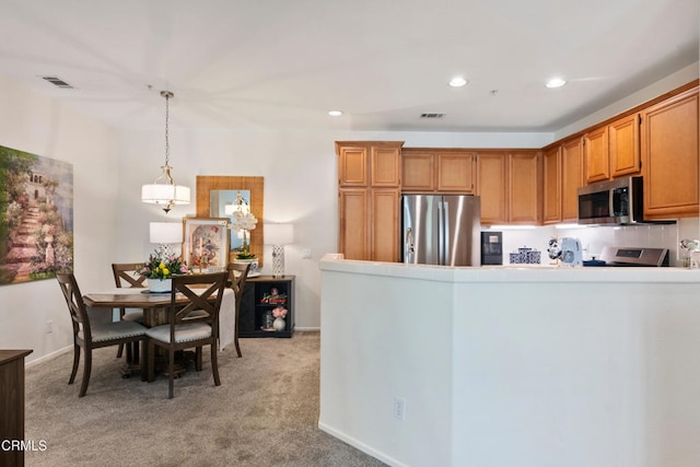 kitchen with visible vents, appliances with stainless steel finishes, and light colored carpet