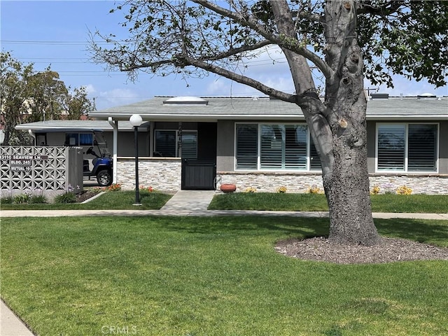 13110 Seaview Ln Unit 245F, Seal Beach, CA 90740 - ranch-style house featuring stone siding, a front lawn, and roof with shingles