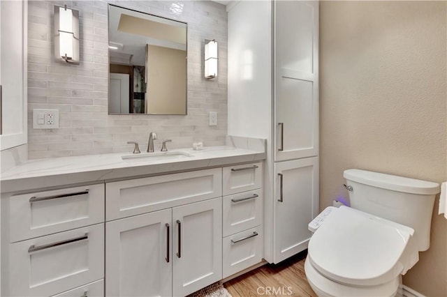 13110 Seaview Ln Unit 245F, Seal Beach, CA 90740 - bathroom with vanity, tasteful backsplash, and wood finished floors