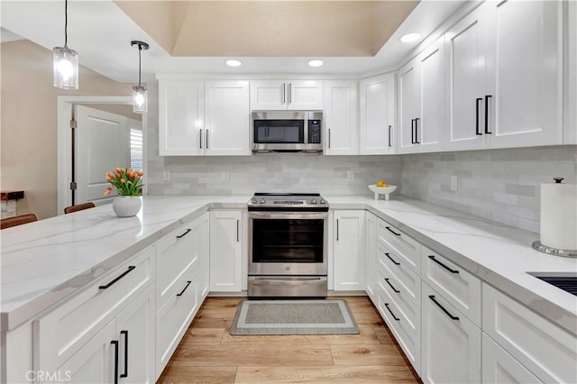 13110 Seaview Ln Unit 245F, Seal Beach, CA 90740 - kitchen with stainless steel appliances, white cabinetry, decorative backsplash, light wood-type flooring, and recessed lighting