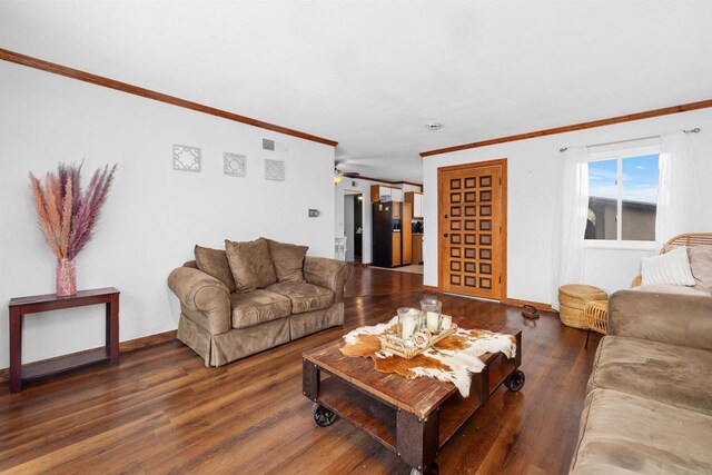 living area featuring wood finished floors, ornamental molding, baseboards, and visible vents