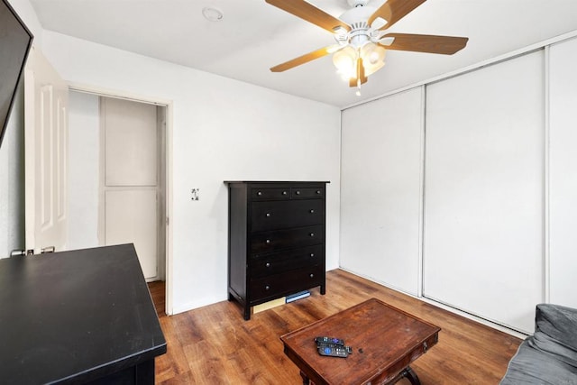interior space with a ceiling fan and wood finished floors