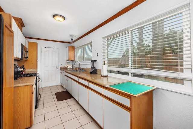 3846 Marcwade Ct, San Diego, CA 92154 - kitchen featuring black microwave, stainless steel gas range, a sink, light tile patterned floors, and white cabinets