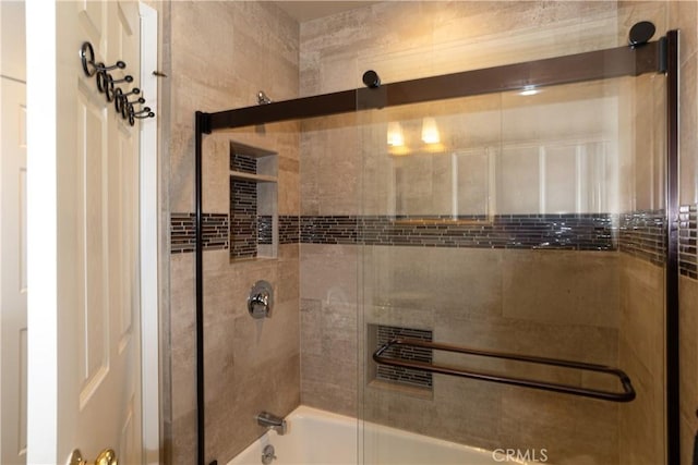 full bath featuring combined bath / shower with glass door