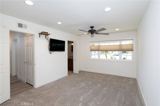 carpeted empty room featuring baseboards, visible vents, recessed lighting, and a ceiling fan