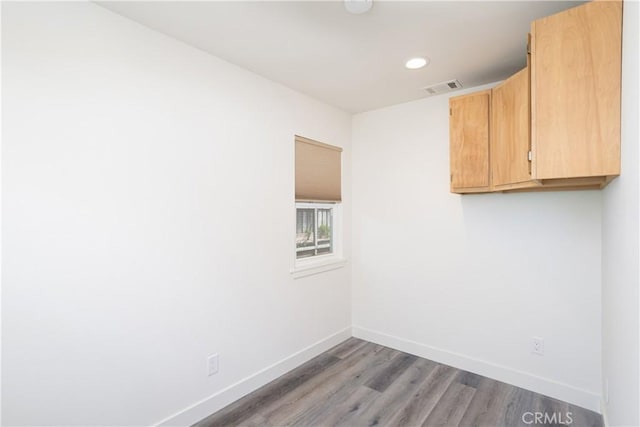 unfurnished room with baseboards, visible vents, light wood-style floors, and recessed lighting