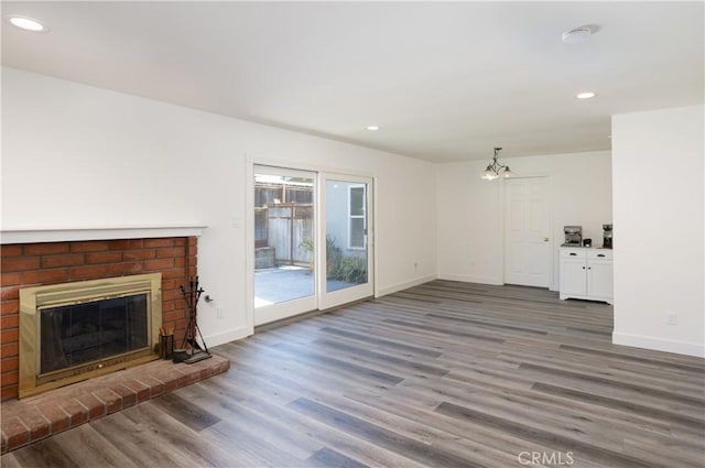 508 Launa Ln, Arroyo Grande, CA 93420 - unfurnished living room with wood finished floors, recessed lighting, baseboards, a fireplace, and a chandelier