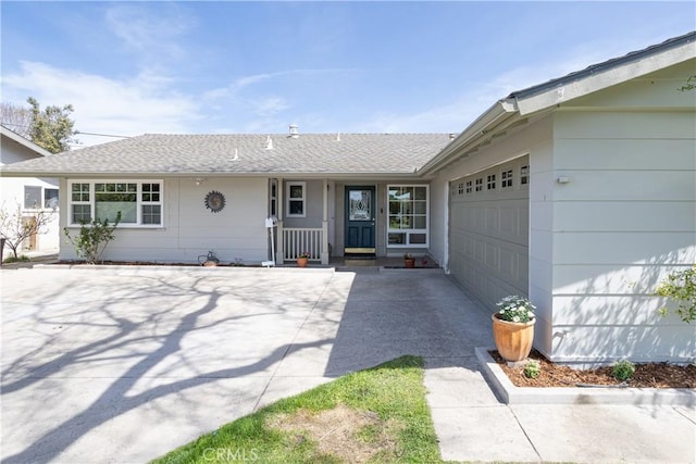 single story home featuring driveway, a shingled roof, and a garage