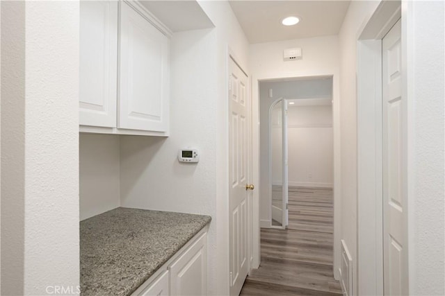 interior space with wood finished floors and recessed lighting