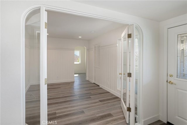 508 Launa Ln, Arroyo Grande, CA 93420 - corridor with french doors, arched walkways, wood finished floors, and baseboards
