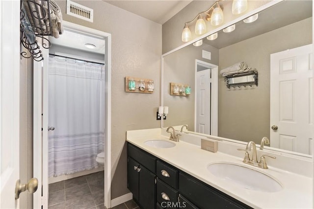 27089 Adelanto Dr, Corona, CA 92883 - bathroom featuring visible vents, a sink, double vanity, and toilet