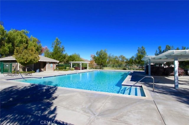 27089 Adelanto Dr, Corona, CA 92883 - community pool with a pergola, fence, and a patio area