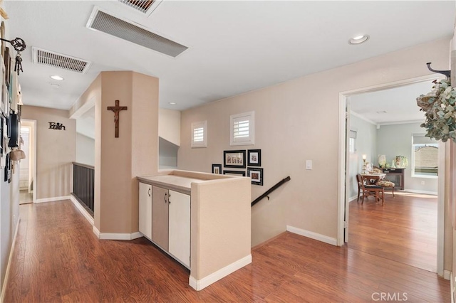27089 Adelanto Dr, Corona, CA 92883 - kitchen with white cabinets, wood finished floors, and visible vents