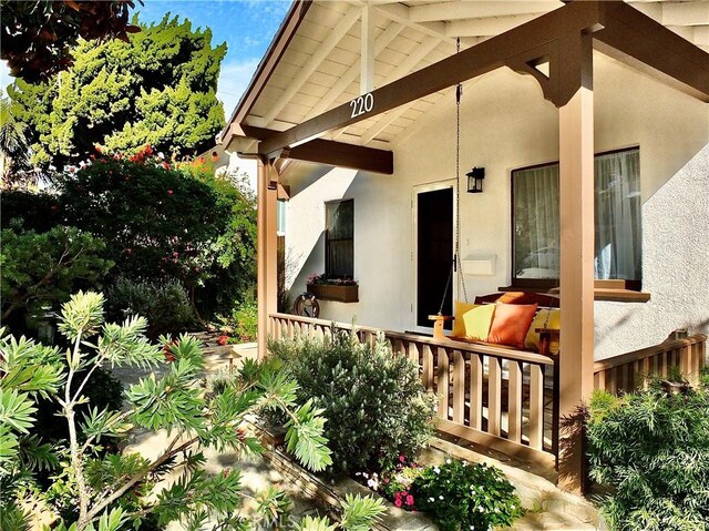 220 Roycroft Ave, Long Beach, CA 90803 - view of exterior entry with stucco siding and covered porch