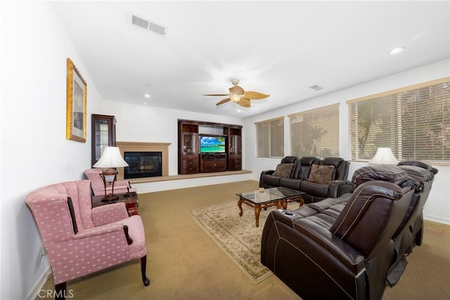 15686 Iron Spring Ln, Fontana, CA 92336 - living area featuring carpet floors, a glass covered fireplace, a ceiling fan, and recessed lighting