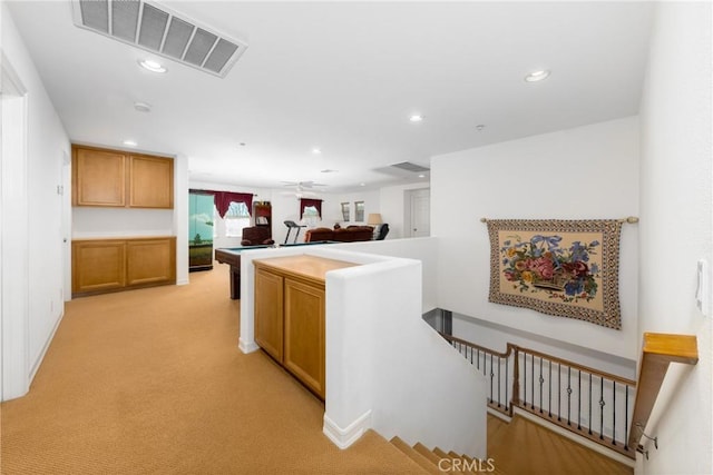 15686 Iron Spring Ln, Fontana, CA 92336 - kitchen with recessed lighting, light carpet, brown cabinetry, and ceiling fan