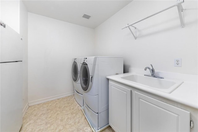 15686 Iron Spring Ln, Fontana, CA 92336 - laundry area with washer and clothes dryer and cabinet space