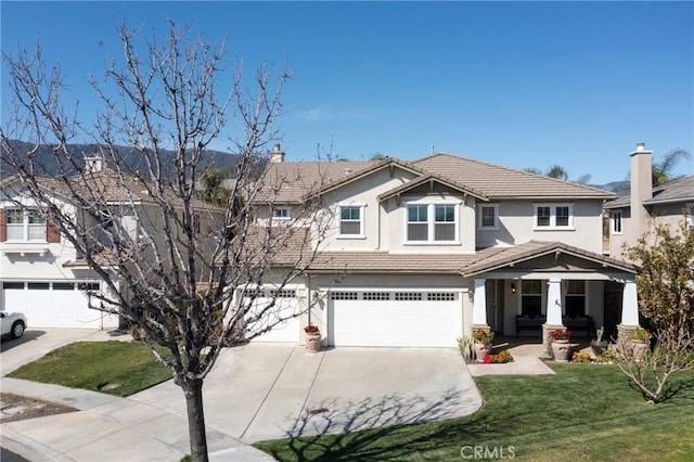 15686 Iron Spring Ln, Fontana, CA 92336 - view of front facade featuring driveway, an attached garage, a tiled roof, and stucco siding