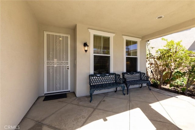 15686 Iron Spring Ln, Fontana, CA 92336 - view of exterior entry featuring stucco siding and a porch