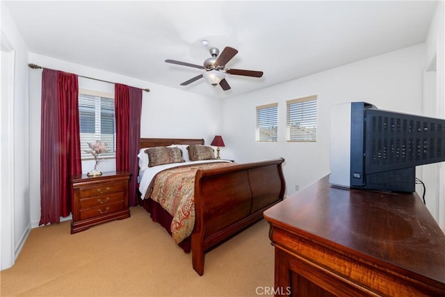 15686 Iron Spring Ln, Fontana, CA 92336 - bedroom featuring multiple windows, ceiling fan, and light colored carpet
