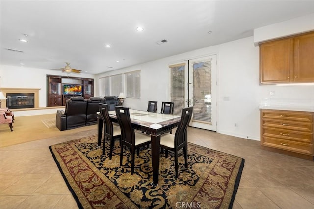 15686 Iron Spring Ln, Fontana, CA 92336 - dining space with light tile patterned floors, ceiling fan, recessed lighting, and a glass covered fireplace