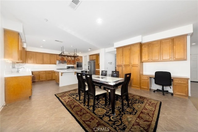 15686 Iron Spring Ln, Fontana, CA 92336 - dining room featuring built in study area, light tile patterned floors, and recessed lighting