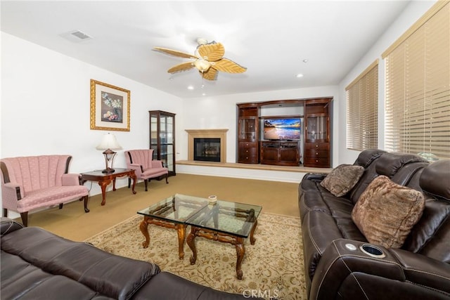 15686 Iron Spring Ln, Fontana, CA 92336 - carpeted living room featuring ceiling fan, a glass covered fireplace, and recessed lighting