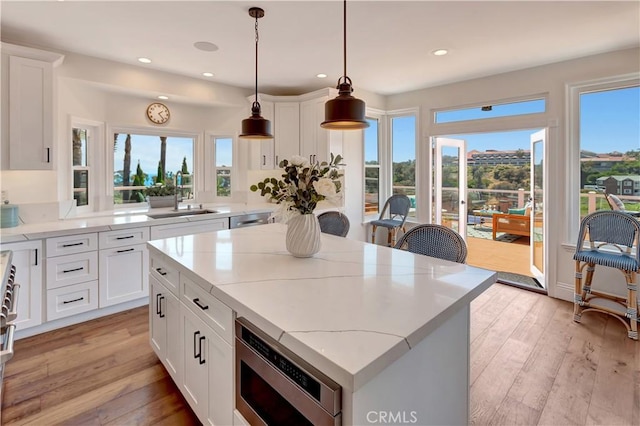 25252 Manzanita Dr, Dana Point, CA 92629 - kitchen featuring a sink, stainless steel microwave, plenty of natural light, and recessed lighting