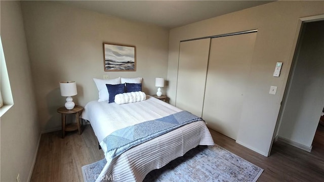bedroom with baseboards, a closet, and wood finished floors