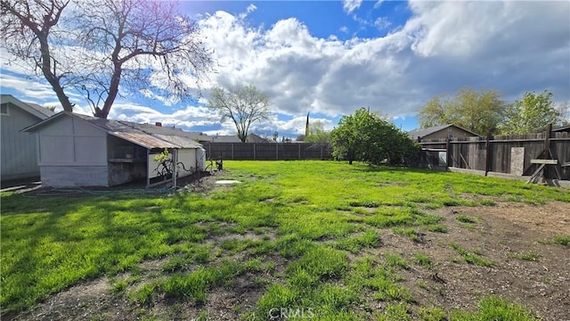 view of yard with an outbuilding and a fenced backyard