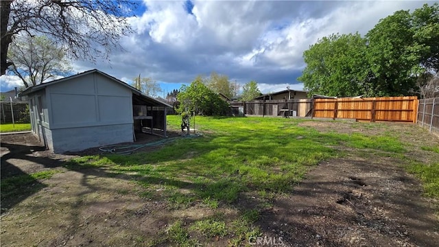 view of yard with an outbuilding, fence, and a pole building