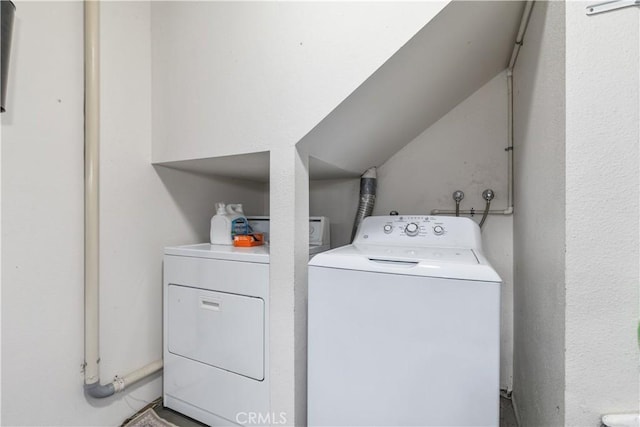 washroom featuring washing machine and dryer and laundry area