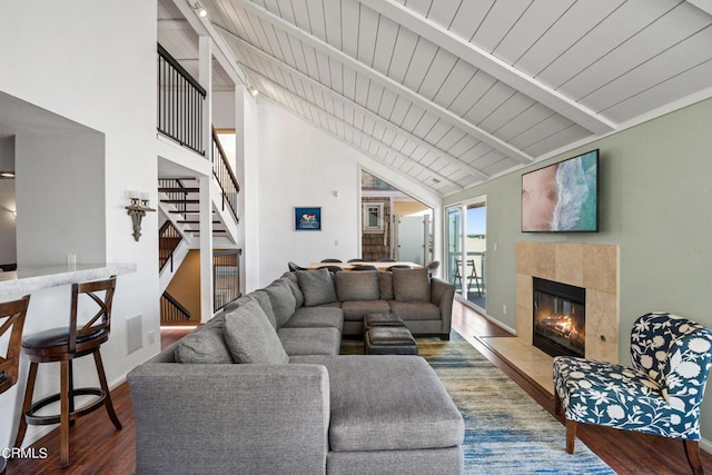 3371 Ocean Dr, Oxnard, CA 93035 - living room with a tiled fireplace, wood ceiling, stairway, vaulted ceiling with beams, and wood finished floors