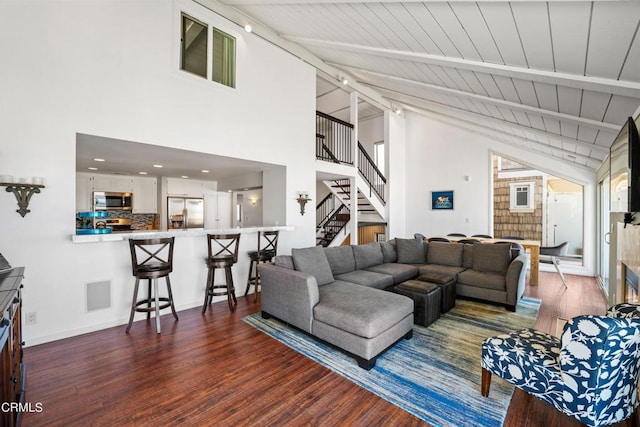 3371 Ocean Dr, Oxnard, CA 93035 - living room with stairs, wood finished floors, beamed ceiling, baseboards, and visible vents