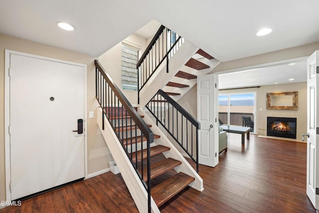 3371 Ocean Dr, Oxnard, CA 93035 - entrance foyer with recessed lighting, wood finished floors, a glass covered fireplace, and stairway