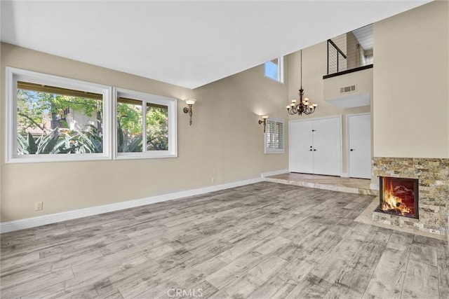22839 Ridge Route Ln, Lake Forest, CA 92630 - unfurnished living room with baseboards, wood finished floors, visible vents, and a notable chandelier