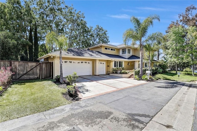 22839 Ridge Route Ln, Lake Forest, CA 92630 - traditional home featuring concrete driveway, a front lawn, an attached garage, fence, and stucco siding