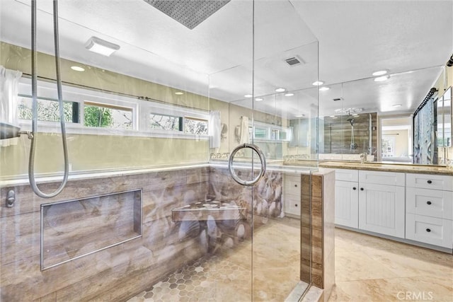 22839 Ridge Route Ln, Lake Forest, CA 92630 - full bathroom with a healthy amount of sunlight, vanity, visible vents, and tiled shower