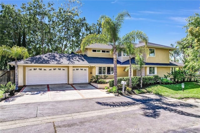 22839 Ridge Route Ln, Lake Forest, CA 92630 - traditional home with concrete driveway, fence, a garage, a front yard, and stucco siding