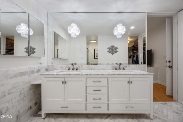 380 S Orange Grove Blvd Unit 6, Pasadena, CA 91105 - full bath with a chandelier, double vanity, a spacious closet, and tile walls