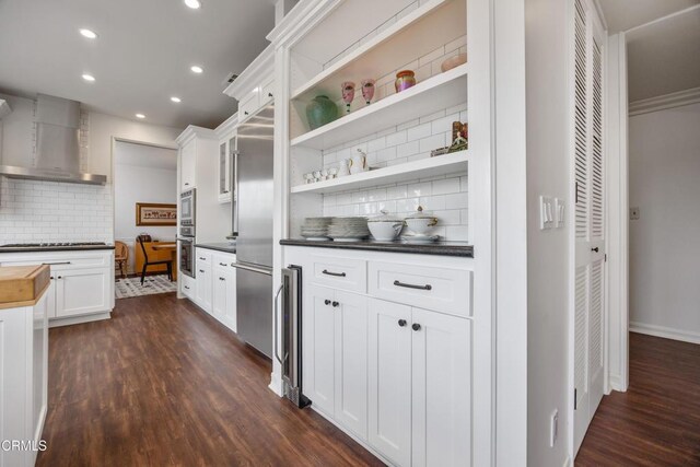 380 S Orange Grove Blvd Unit 6, Pasadena, CA 91105 - kitchen with wall chimney exhaust hood, built in appliances, tasteful backsplash, dark wood-style flooring, and recessed lighting