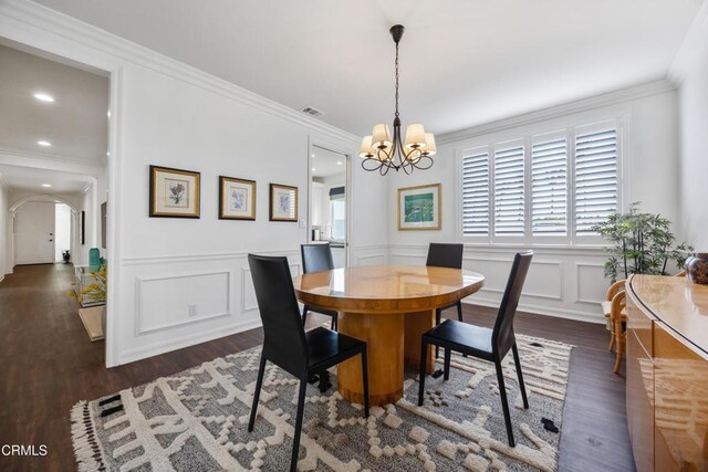 380 S Orange Grove Blvd Unit 6, Pasadena, CA 91105 - dining space with a chandelier, dark wood-style floors, a decorative wall, ornamental molding, and wainscoting