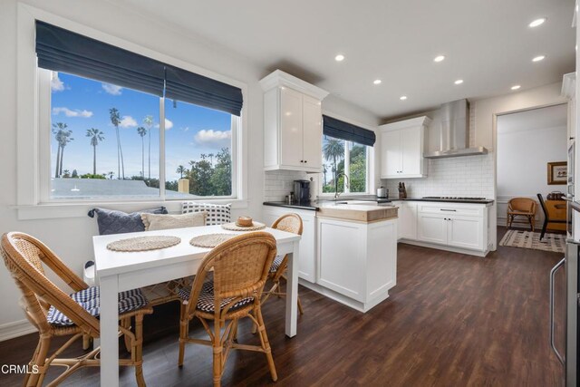 380 S Orange Grove Blvd Unit 6, Pasadena, CA 91105 - kitchen with wall chimney range hood, dark wood-style flooring, tasteful backsplash, white cabinets, and recessed lighting